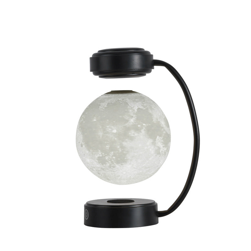 Svävande månlampa under svart båge