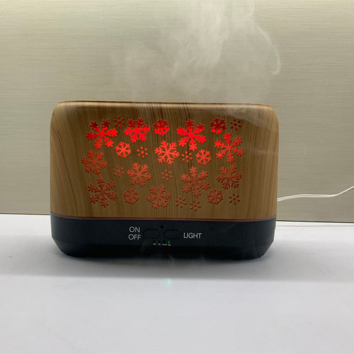 Doftspridare formad som snöflinga med flamljus